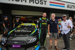 Czech president Petr Pavel stands alongside Martin Doubek (left) and Jerome Galpin (right) in his historic EuroNASCAR test drive