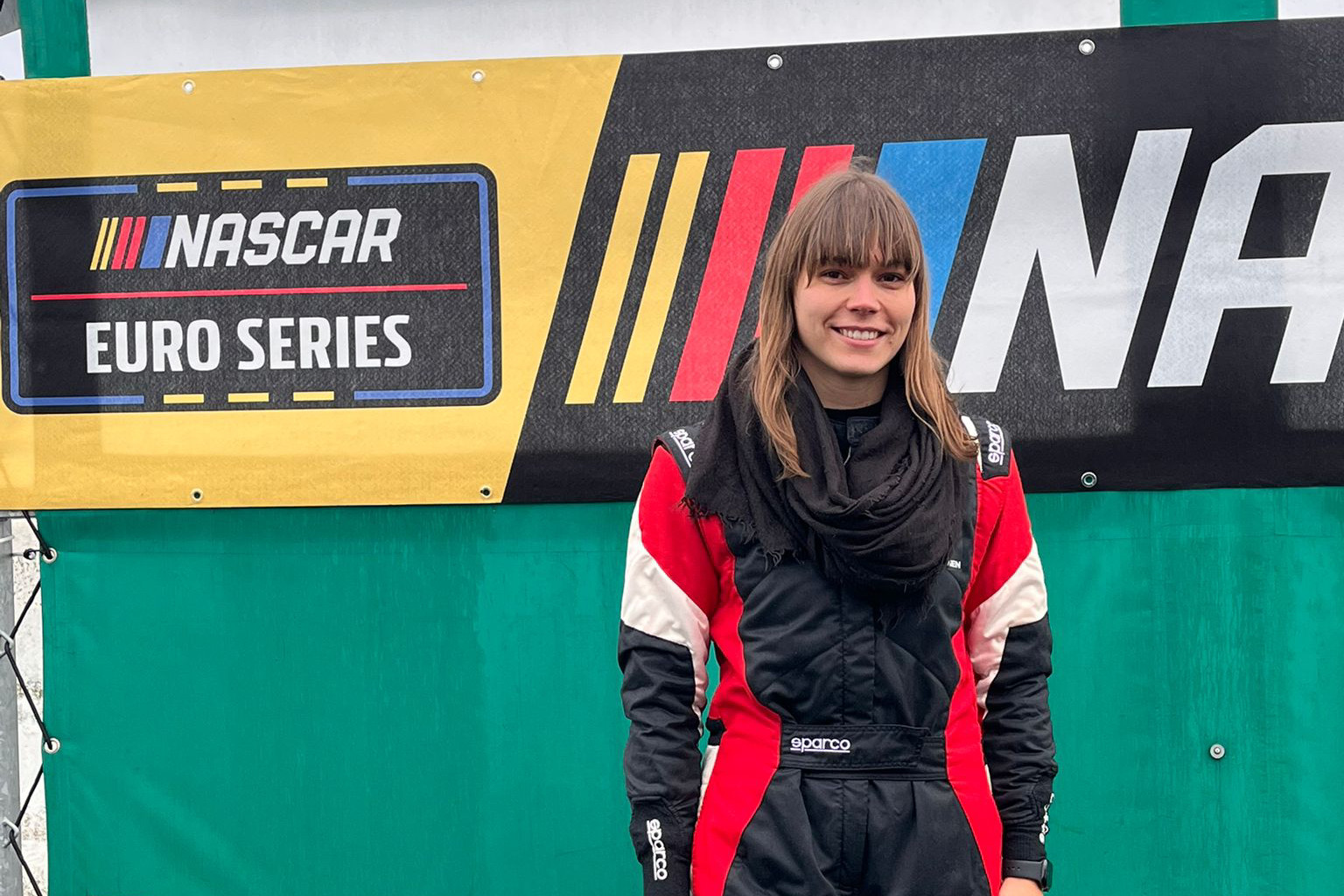 Nathalie Neumann stands in front of the EuroNASCAR banners during the January 2026 NASCAR Recruitment Tests
