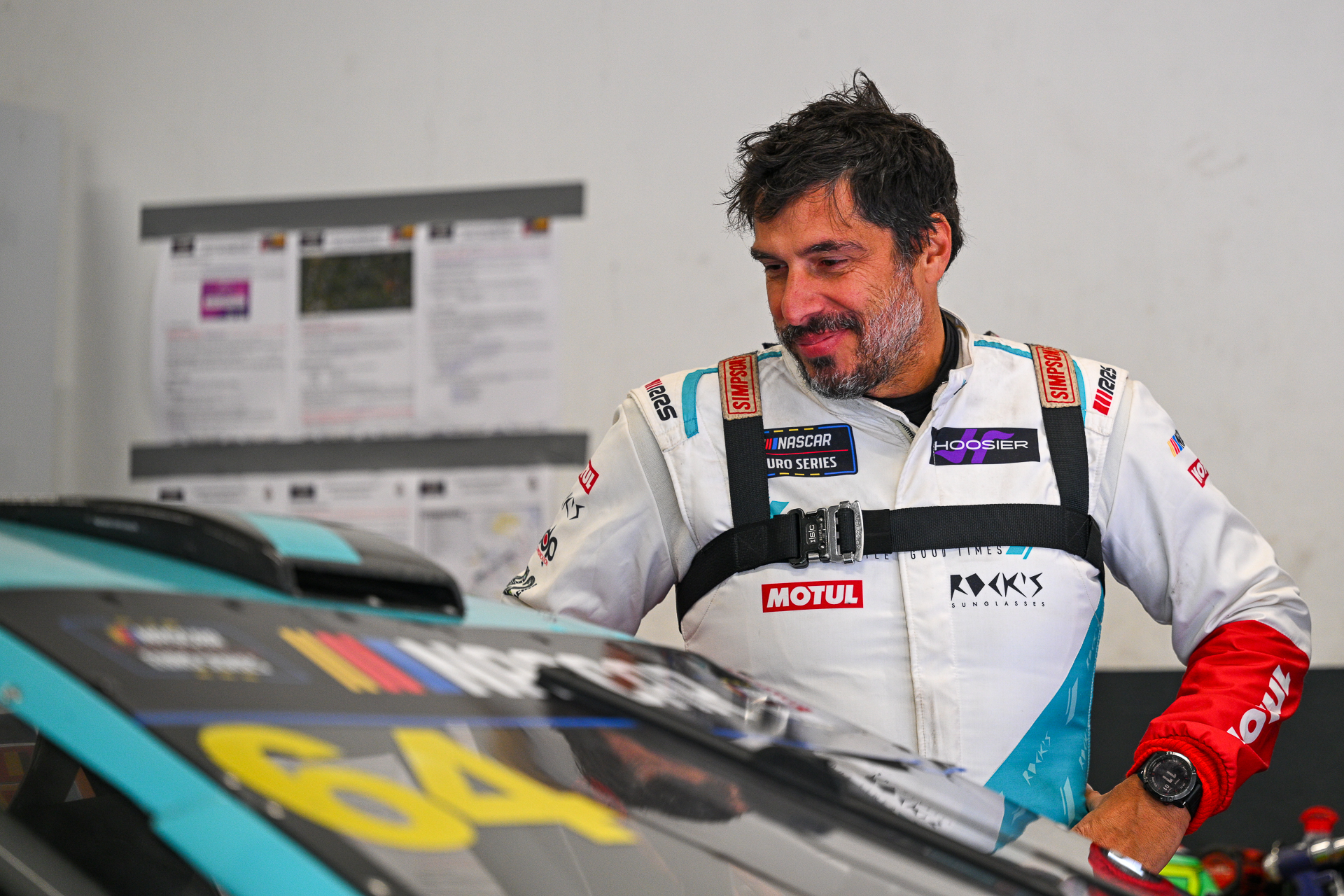 Nuno Caetano looks happily to his #64 Ford Mustang during the 2025 EuroNASCAR Finals at Circuit Zolder