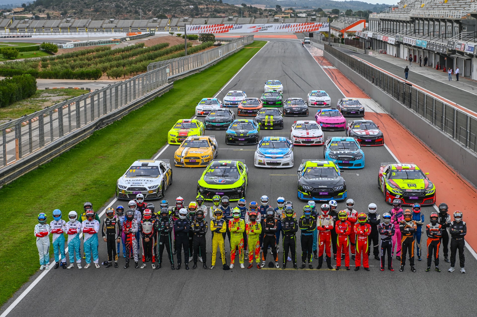 The 2025 drivers line up in front of their cars during the annual start-of-season photo shoot at Circuit Ricardo Tormo