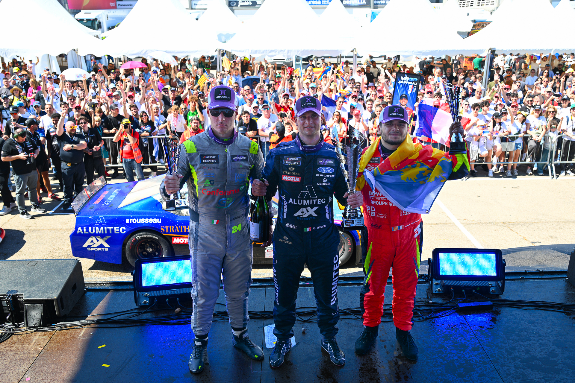 Gianmarco Ercoli (center) celebrates his first win in the V8GP era alongside podium finishers and title contenders Vittorio Ghirelli (left) and Paul Jouffreau (right)