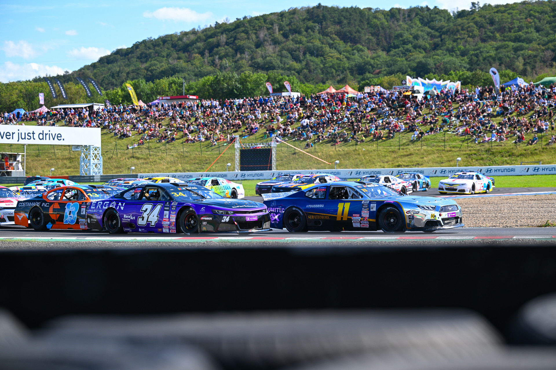 Gianmarco Ercoli (#11) passes Thomas Toffel (#34) in what turned out to be the most defining moment of EuroNASCAR V8GP Race 2 at Autodrom Most