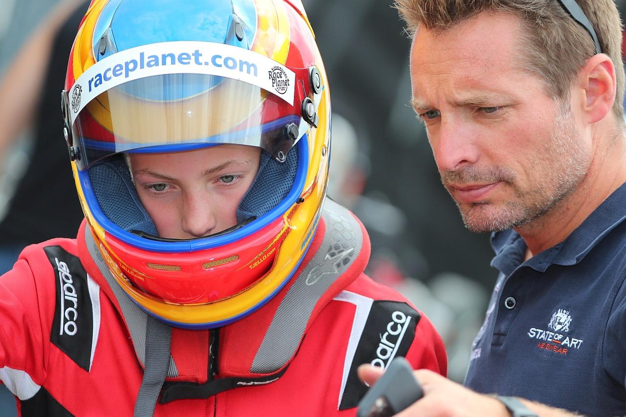 Robin Bleekemolen receives guidance from her father Sebastiaan prior to a race