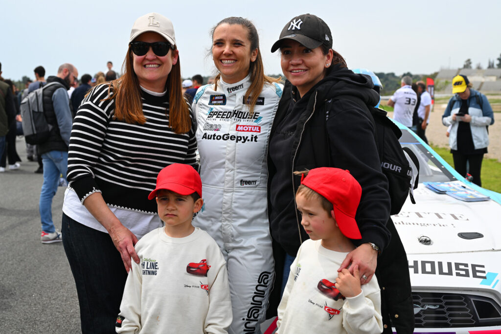 Arianna Casoli takes a photo with several female EuroNASCAR fans and their kids during the 2025 Valencia NASCAR Fest at Circuit Ricardo Tormo