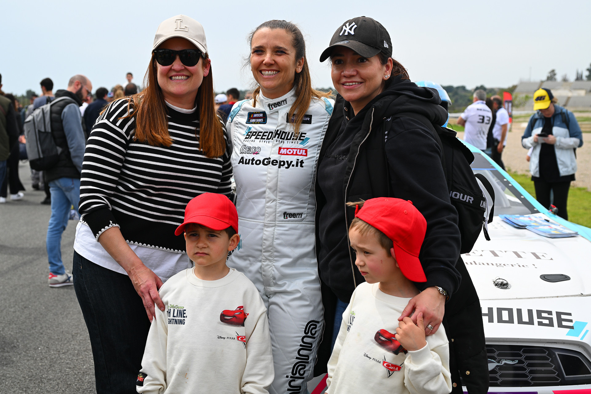 Arianna Casoli takes a photo with several female EuroNASCAR fans and their kids during the 2025 Valencia NASCAR Fest at Circuit Ricardo Tormo