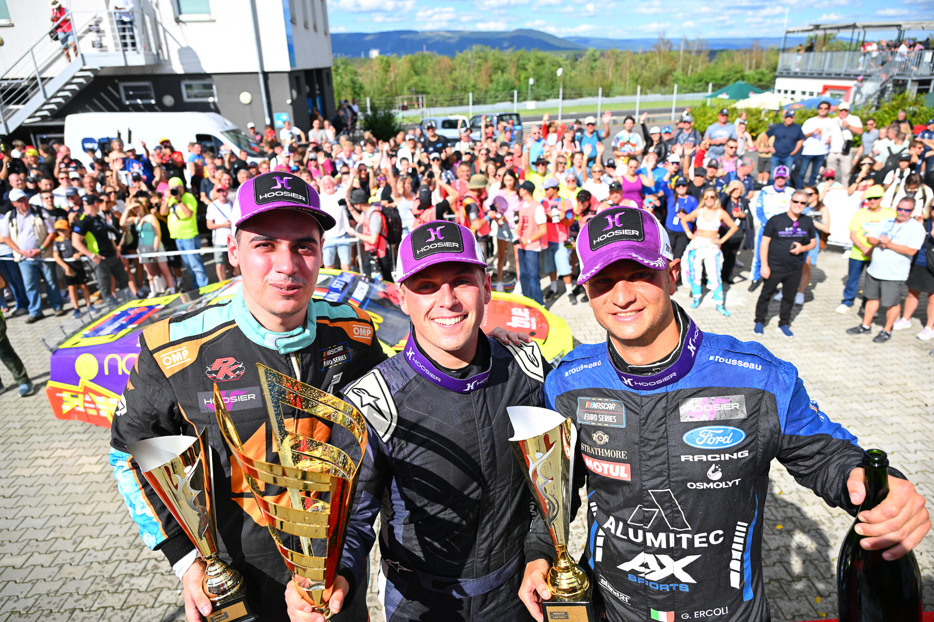 First-time V8GP winner Jordan O'Brien (center) stands alongside Gianmarco Ercoli (right) and Thomas Krasonis (left) in the podium celebrations at Autodrom Most